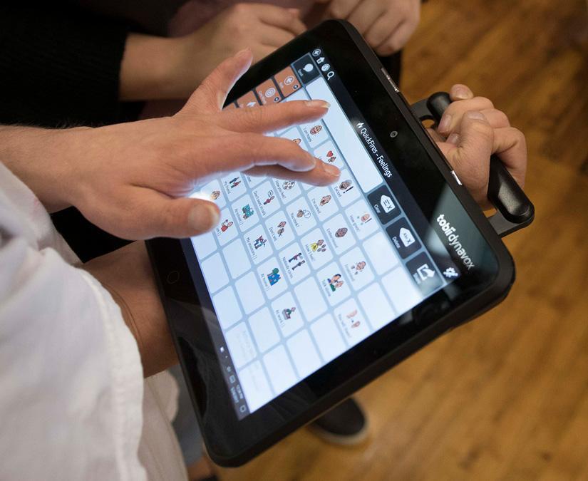 Tobii Dynavox I-110 SGD heald by integrated handle featuring touch screen and PCS symbols used on the TD Snap app