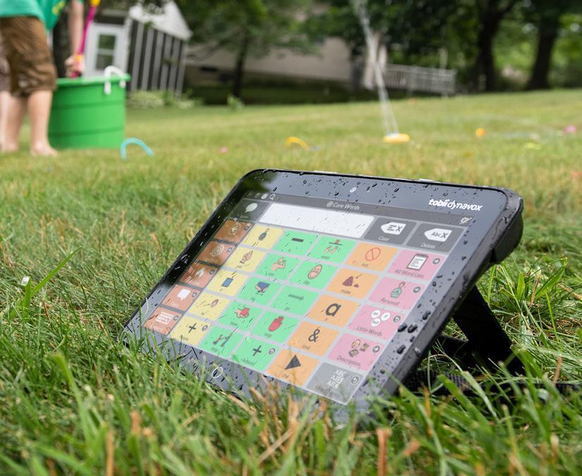 Angled view of the Tobii Dynavox I-110 SGD outdoors in grass featuring the TD Snap AAC app 