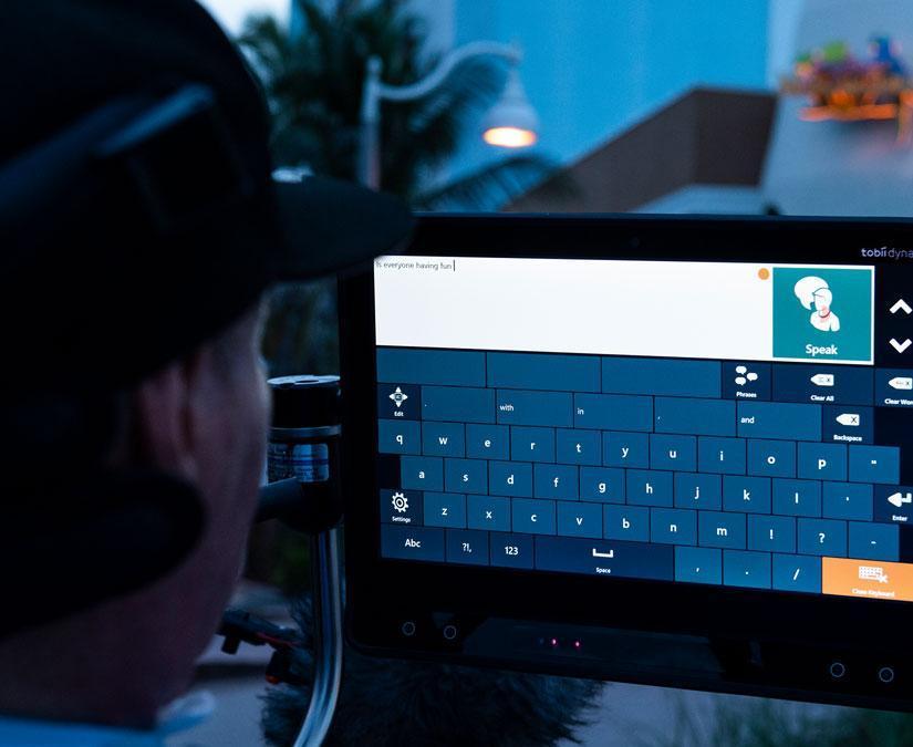 Man using Tobii Dynavox Communicator 5 on his I-16 device
